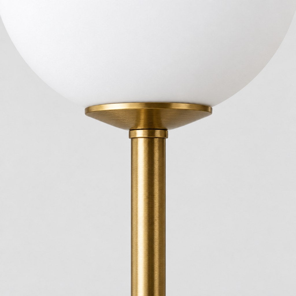Close up of the brass stem and opal glass globe of the Elwood table lamp