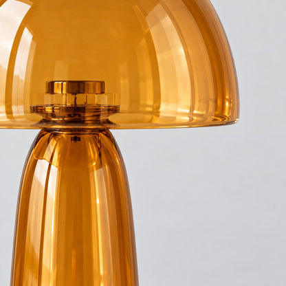Close up of the amber glass dome and stem of the Lumi table lamp